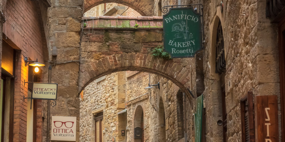 Volterra, Italy - April 10, 2019: Amazing view with a narrow picturesque medieval street of old town of Volterra in Tuscany, Italy